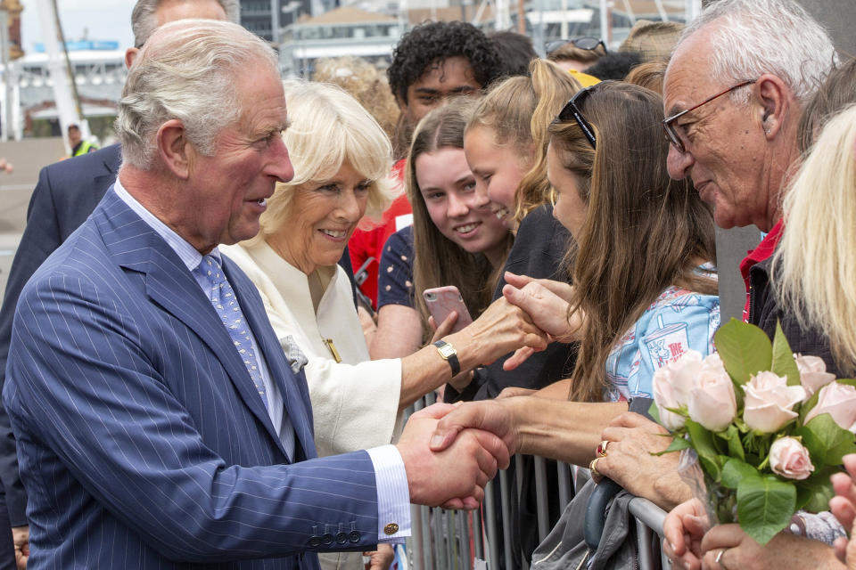 Britain's Prince Charles, left, and his wife Camilla, second left, greet members of the public during a walk at Viaduct Harbour in Auckland during their royal visit to New Zealand, Tuesday, Nov. 19, 2019. The visit is part of a week-long tour of the country which also takes in Christchurch and Kaikoura. (David Rowland/Pool Photo via AP)
