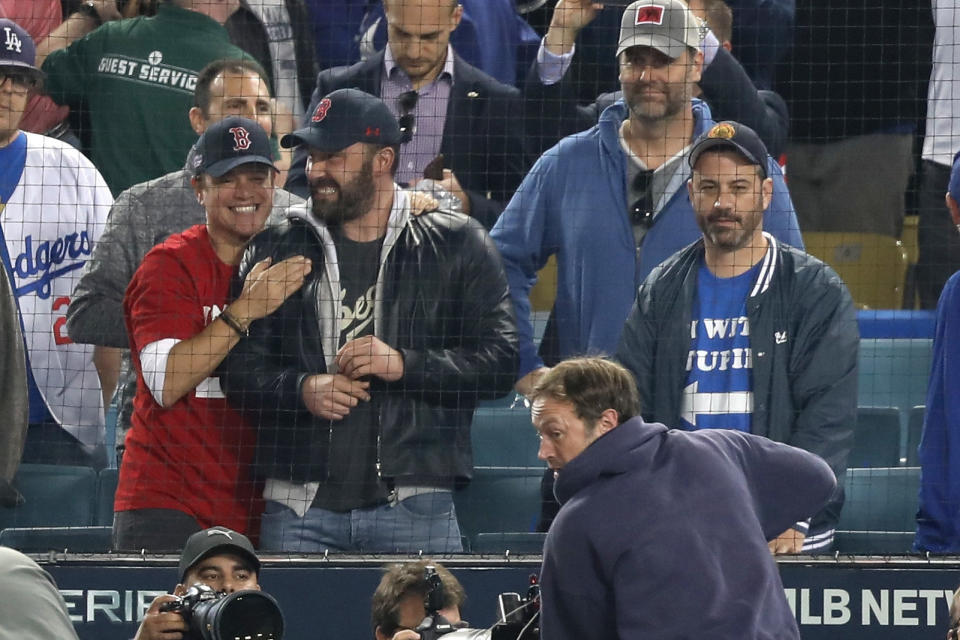 Matt Damon and Ben Affleck celebrate the Red Sox' victory while Jimmy Kimmel looks on in disappointment. (Photo: Jerritt Clark via Getty Images)