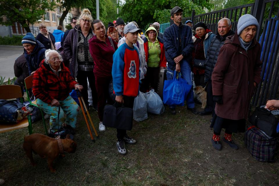 Vovchansk area residents, who fled due to Russian military strikes, gather at an evacuation centre compound in Kharkiv region (REUTERS)