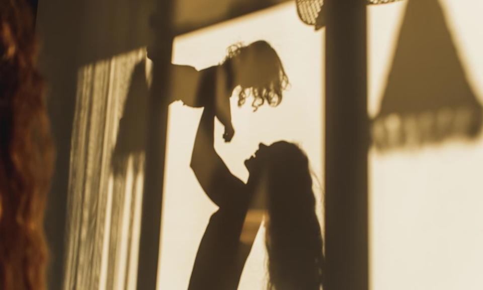 shadows on wall of mother playing with her daughter