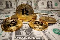 FILE PHOTO: Representations of virtual currency Bitcoin are placed on U.S. Dollar banknotes