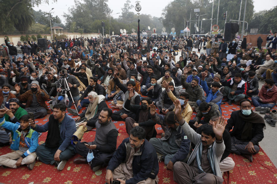 Shiite Muslims chant slogans during a sit-in to protest against the killing of coal mine workers by gunmen near the Machh coal field, in Lahore, Pakistan, Friday, Jan. 8, 2021. Pakistan's prime minister Friday appealed the protesting minority Shiites not to link the burial of 11 coal miners from Hazara community who were killed by the Islamic State group to his visit to the mourners, saying such a demand amounted to blackmailing the country's premier. (AP Photo/K.M. Chaudary)