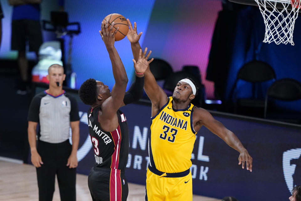 Miami Heat forward Bam Adebayo (13) tries to shoot over Indiana Pacers center Myles Turner (33) during the first half of an NBA basketball first round playoff game, Tuesday, Aug. 18, 2020, in Lake Buena Vista, Fla. (AP Photo/Ashley Landis, Pool)