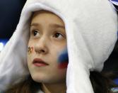 A young Russian hockey fans watches the women's game between Russia and Germany at Shayba Arena during the 2014 Winter Olympics, Sunday, Feb. 9, 2014, in Sochi, Russia. (AP Photo/Julio Cortez)