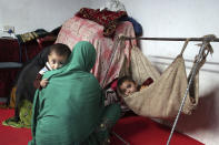 In this Thursday, May 30, 2019 photo, members of Farmanullah Shirzad's family who fled their village in Nangarhar province in late April as Islamic State group fighters swept through the area, are seen at their temporary home in the city of Jalalabad east of Kabul, Afghanistan. The Islamic State group has lost its caliphate in Syria and Iraq, but in the forbidding mountains of northeastern Afghanistan the group is expanding its footprint, recruiting new fighters and plotting attacks in the United States and other Western countries. (AP Photo/Rahmat Gul)