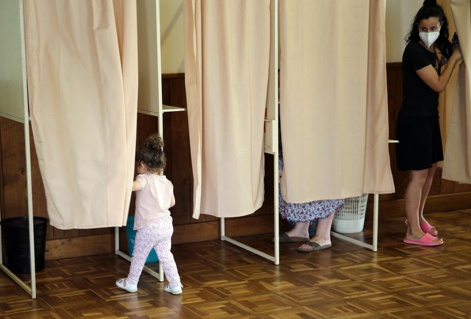 A woman leaves the voting booth Sunday, June 19, 2022 in Souraide, southwestern France. French voters are going to the polls for the final round of key parliamentary elections that will demonstrate how much legroom the electorate are willing to give President Emmanuel Macron’s party to implement his ambitious domestic agenda. (AP Photo/Bob Edme)