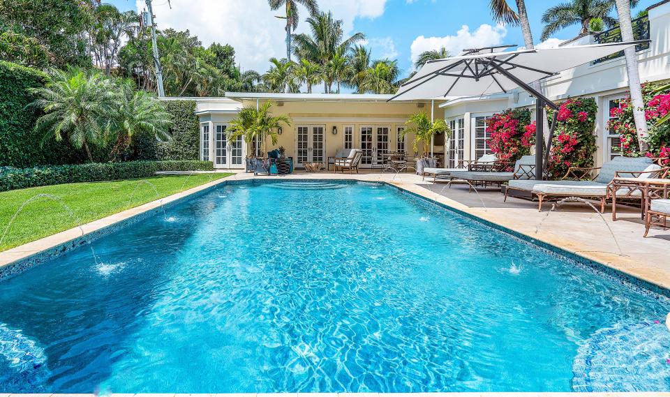 The two wings of a Palm Beach Regency-style house at 168 Kings Road in Palm Beach wrap around the pool area. The property just changed hands for a recorded $14 million.