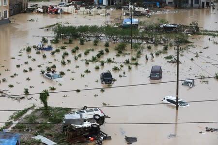 Cars are partially submerged in floodwaters after Typhoon Lekima hit Dajing town in Wenzhou, Zhejiang