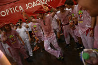 <p>A reveler dances after the launch of the <em>chupinazo</em> rocket to celebrate the official opening of the 2017 San Fermín Fiesta in Pamplona, Spain, on July 6. (Photo: Alvaro Barrientos/AP) </p>