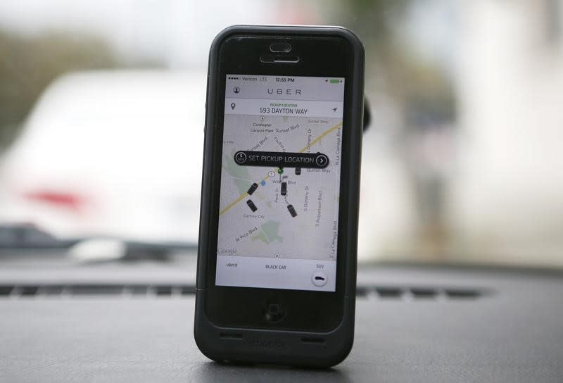 An Uber app is seen on an iPhone in Beverly Hills, California, December 19, 2013. Uber has entered more than 60 markets, ranging from its hometown of San Francisco to Berlin to Tokyo. Leaked financials in December indicate that the company, which began connecting passengers with drivers of vehicles for hire about 3-1/2 years ago, is generating $200 million a year in revenue beyond what it pays to drivers. Photo taken December 19, 2013. REUTERS/Lucy Nicholson (UNITED STATES - Tags: BUSINESS TRANSPORT) - RTX1705H