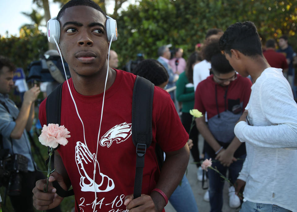 Students wait at a crosswalk as they arrive to attend classes at Marjory Stoneman Douglas High School for the first time since the shooting that killed 17 people on February 14 at the school on February 28, 2018 in Parkland, Florida.