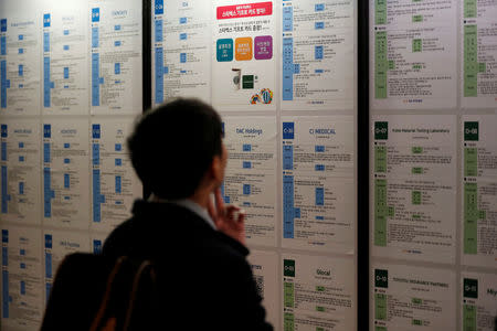 A jobseeker looks at recruitment advertisements during the 2018 Japan Job Fair in Seoul, South Korea, November 7, 2018. Picture taken on November 7, 2018. REUTERS/Kim Hong-Ji