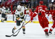 Vegas Golden Knights center Nicolas Roy (10) shoots against Detroit Red Wings defenseman Filip Hronek (17) during the first period of an NHL hockey game Saturday, Dec. 3, 2022, in Detroit. (AP Photo/Duane Burleson)