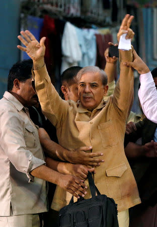 FILE PHOTO: Shahbaz Sharif, brother of ex-prime minister Nawaz Sharif, and leader of Pakistan Muslim League - Nawaz (PML-N) gestures to his supporters during a campaign rally ahead of general elections in the Lyari neighborhood in Karachi, Pakistan June 26, 2018. REUTERS/Akhtar Soomro