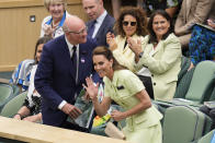 Kate, Princess of Wales waves as she arrives in the Royal Box with AELTC chairman Ian Hewitt ahead of the final of the women's singles between the Czech Republic's Marketa Vondrousova and Tunisia's Ons Jabeur on day thirteen of the Wimbledon tennis championships in London, Saturday, July 15, 2023. (AP Photo/Kirsty Wigglesworth)
