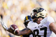 Purdue tight end Payne Durham (87) looks to catch a pass in the end zone ahead of Iowa linebacker Seth Benson, rear, during the first half of an NCAA college football game, Saturday, Oct. 16, 2021, in Iowa City, Iowa. The pass was incomplete. (AP Photo/Charlie Neibergall)