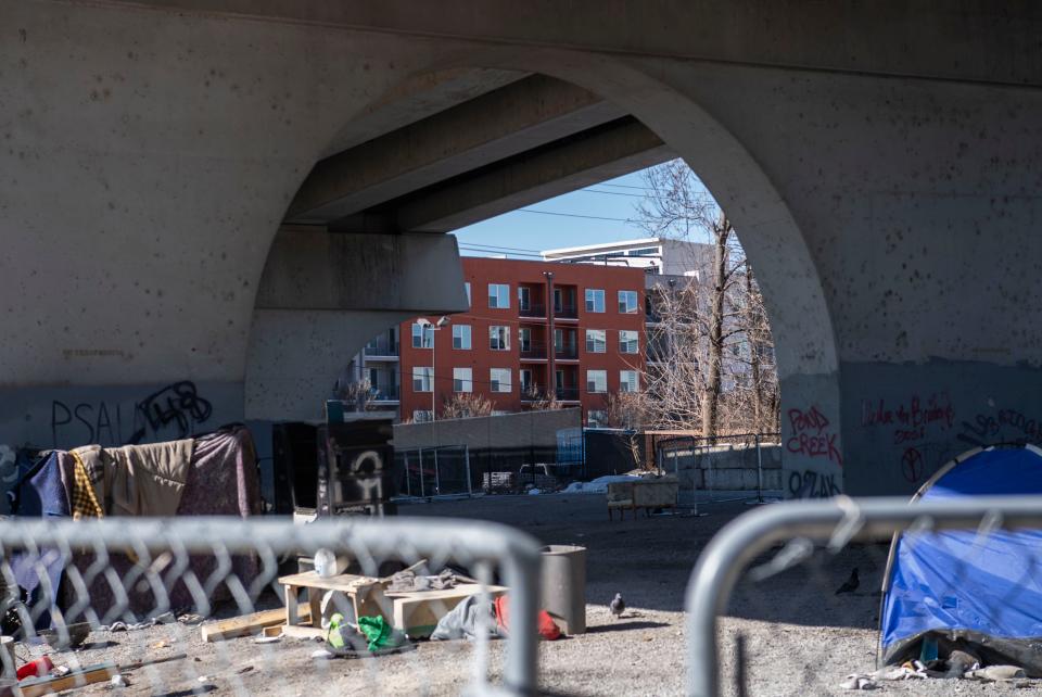 New apartments can be seen from across the site of a long-standing homeless encampment underneath the Jefferson Street Bridge, in Nashville, Tenn., Monday, Feb. 14, 2022. 