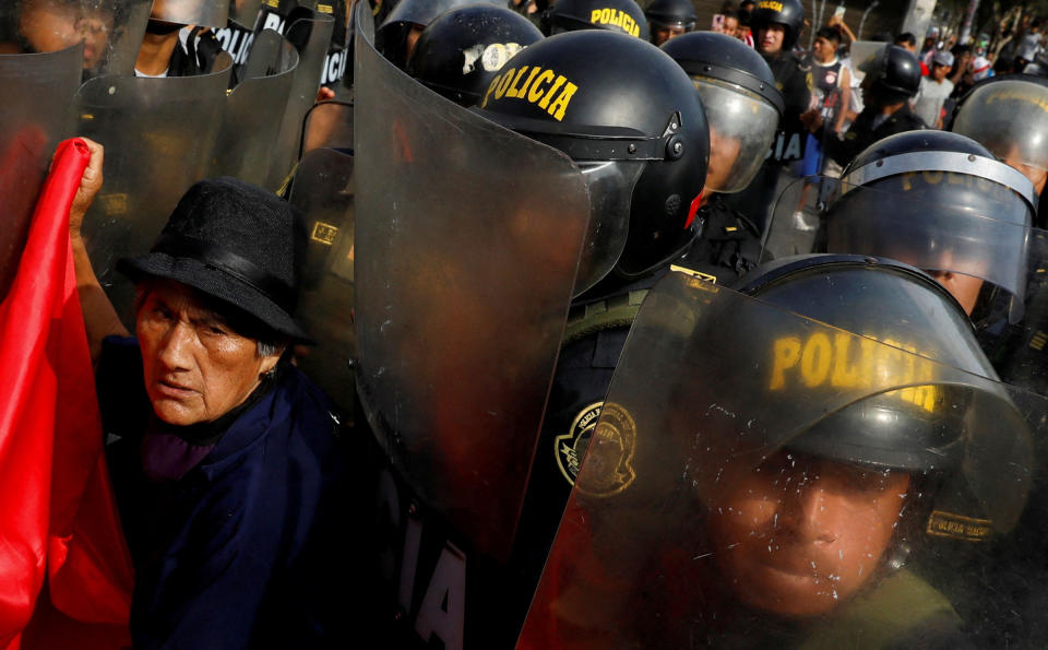 A protester interacts with police during the ‘Take over Lima’ march to demonstrate against Peru’s President Dina Boluarte, following the ousting and arrest of former President Pedro Castillo, in Lima on Jan. 19, 2023.<span class="copyright">Alessandro Cinque—Reuters</span>