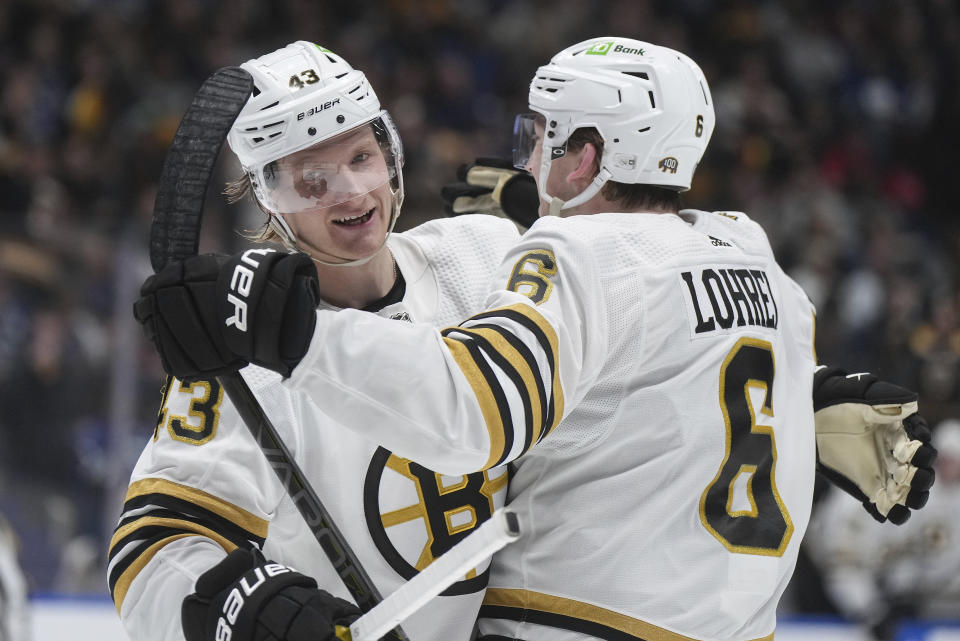 Boston Bruins' Danton Heinen, left, and Mason Lohre, right,i celebrate after Heinen's goal against the Vancouver Canucks during the second period of an NHL hockey game in Vancouver, British Columbia, Saturday, Feb. 24, 2024. (Darryl Dyck/The Canadian Press via AP)