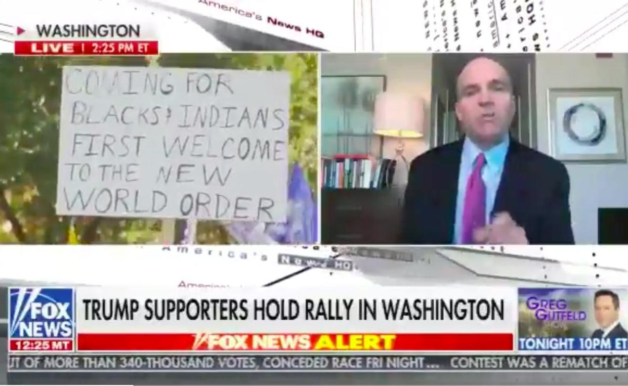 <p>Racist sign spotted at MAGA rally during Fox News broadcast</p> (Screengrab/Fox News)