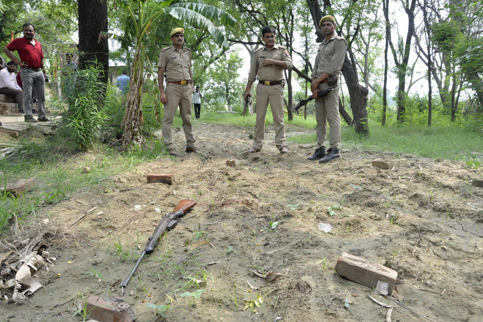 FILE - In this July 3, 2020, file photo, policemen inspect the scene of an ambush in Kanpur, India. A top suspect in dozens of crimes, including the killings of eight police officers last week, was fatally shot Friday, July 10 in police custody while allegedly trying to flee, officials said. (AP Photo, File)