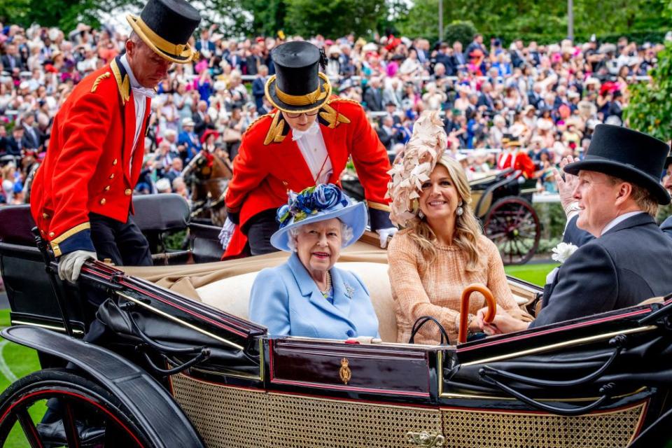 <p>Queen Elizabeth II, King Willem-Alexander of the Netherlands, and Queen Maxima of the Netherlands look on at the crowds from their carriage on day one of Royal Ascot.</p>