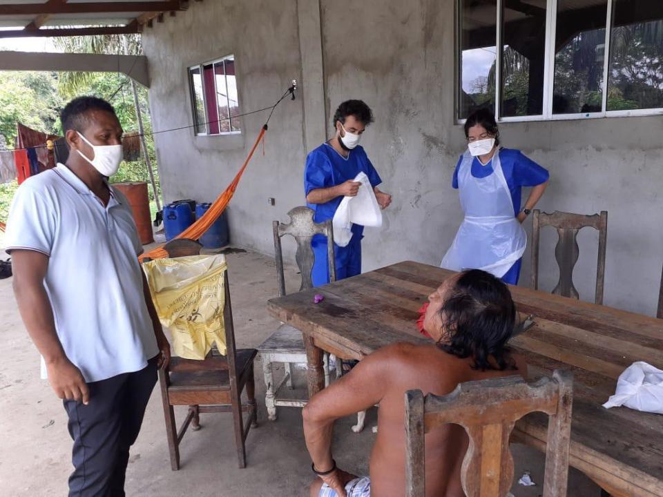 In this photo taken Tuesday, May 26, 2020, medial workers take care of residents of the remote village of Camopi, French Guiana. France's most worrisome virus hotspot is in fact on the border with Brazil - in French Guiana, a former colony where health care is scarce and poverty is rampant. The pandemic is exposing deep economic and racial inequality in French Guiana that residents say the mainland has long chosen to ignore. (AP Photo)