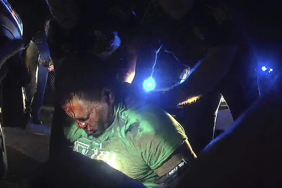 This image from video from Louisiana state police state trooper Dakota DeMoss' body-worn camera, shows troopers holding up Ronald Greene before paramedics arrived on May 10, 2019, outside of Monroe, La. Three years ago, when a beaten and battered Ronald Greene drew his final breath on a rural roadside, his death in Louisiana State Police custody seemed destined for obscurity. Family members were told falsely that he died in a car crash following a high-speed chase. Body camera footage of white troopers stunning, punching and dragging the Black motorist remained secret and withheld from his initial autopsy. Three years later the case has engulfed Louisiana’s elite law enforcement agency in controversy. (Louisiana State Police via AP)