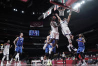 United States's Jrue Holiday (12) and Jayson Tatum (10) leap for a rebound during a men's basketball preliminary round game against the Czech Republic at the 2020 Summer Olympics, Saturday, July 31, 2021, in Saitama, Japan. (AP Photo/Eric Gay)