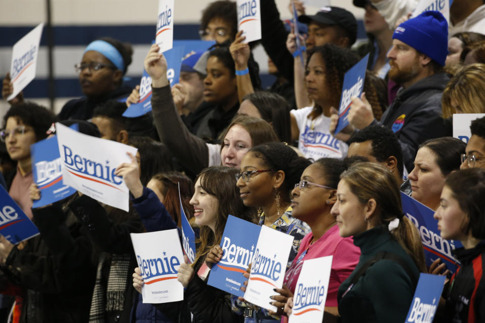 FILE - In this Feb. 29, 2020, file photo, supporters of Democratic presidential candidate Sen. Bernie Sanders, I-Vt., hold signs as they listen during a campaign rally in Virginia Beach, Va. (AP Photo/Steve Helber, File)