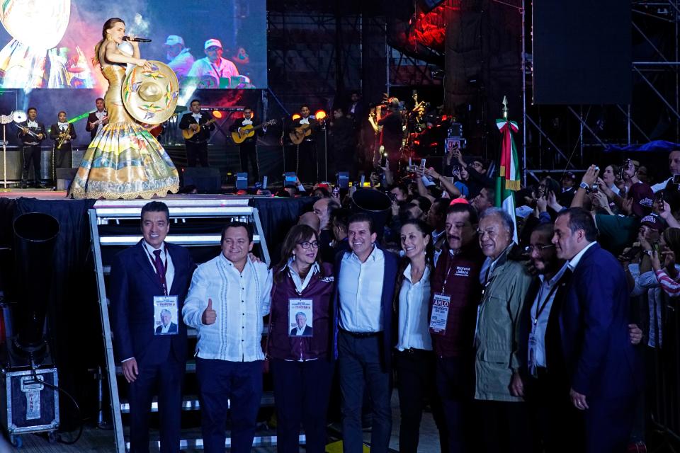 Claudia Sheinbaum, then a candidate for Mexico City mayor, fifth from right, stands with other candidates for a photo as Mexican singer Belinda performs during the closing campaign rally for presidential candidate Andres Manuel Lopez Obrador at Azteca stadium in Mexico City, on June 27, 2018.