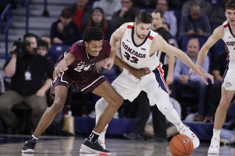 Texas Southern forward John Walker III (24) and Gonzaga forward Killian Tillie (33) go after the ball during the second half of an NCAA college basketball game in Spokane, Wash., Wednesday, Dec. 4, 2019. Gonzaga won 101-62. (AP Photo/Young Kwak)