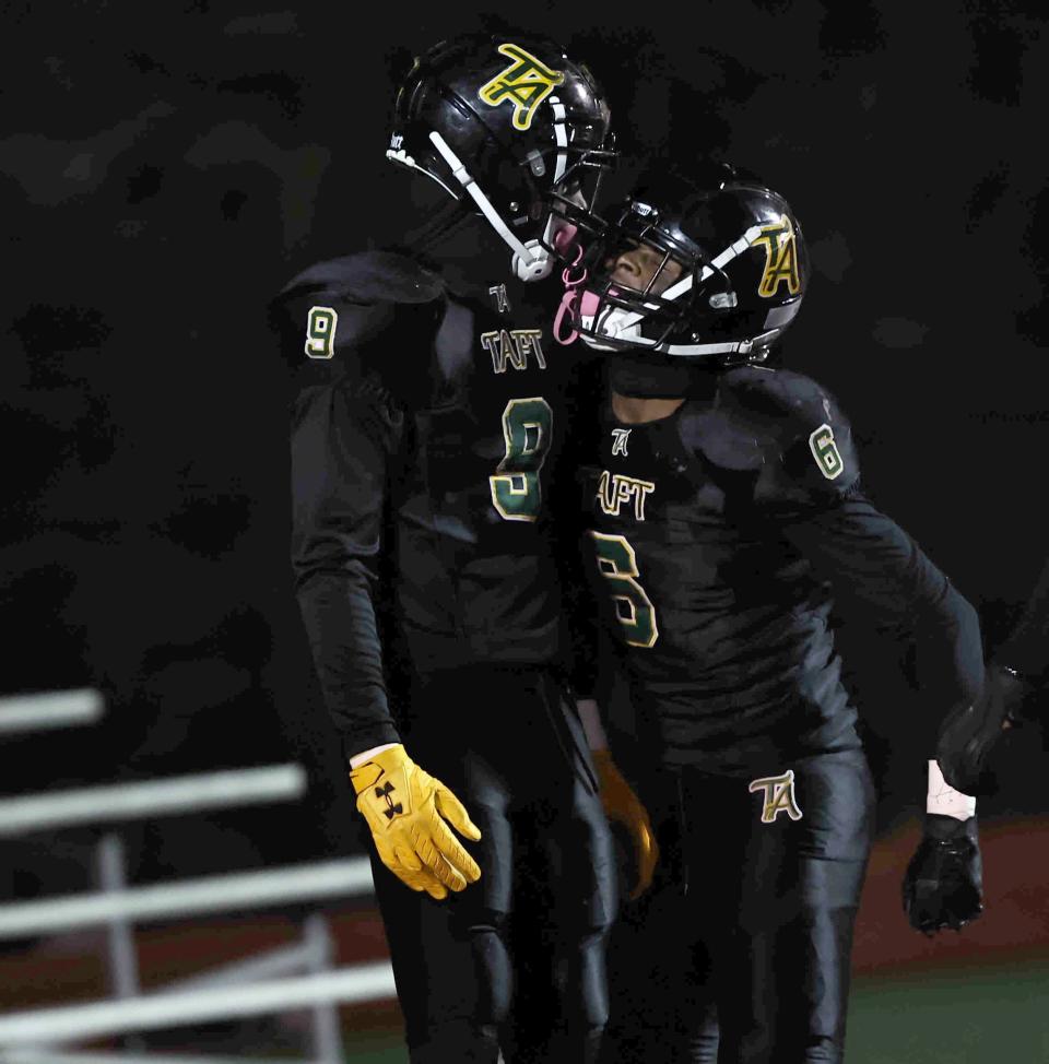 Taft's Geno Jackson (6) celebrates with Elias Rudolph after Rudolph blocked a punt and returned it for a touchdown during a playoff game between Taft and McNicholas high schools Saturday, Nov 12. Rudolph is the Southwest District Division IV Defensive Player of the Year.