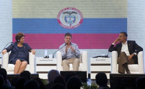 President Juan Manuel Santos (C) of Colombia speaks alongside US President Barack Obama (R) and President Dilma Rousseff of Brazil during the CEO Summit on the sidelines of the Summit of the Americas in Cartagena, Colombia