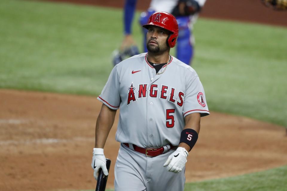 Angels' Albert Pujols walks to the dugout.