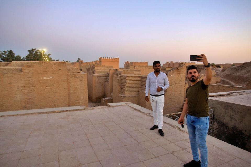 People visit the archaeological site of Babylon, Iraq, Friday, July 5, 2019. Iraq on Friday celebrated the UNESCO World Heritage Committee's decision to name the historic city of Babylon a World Heritage Site in a vote held in Azerbaijan's capital, years after Baghdad began campaigning for the site to be added to the list. (AP Photo/Anmar Khalil)