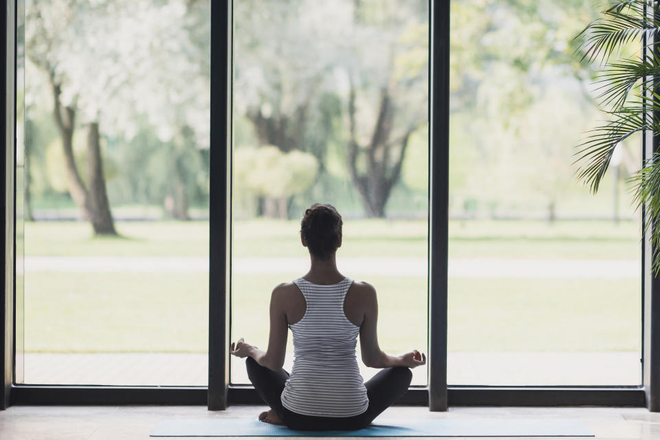 Young girl meditating and doing yoga in class. Meditation, relaxation at home and harmony concept