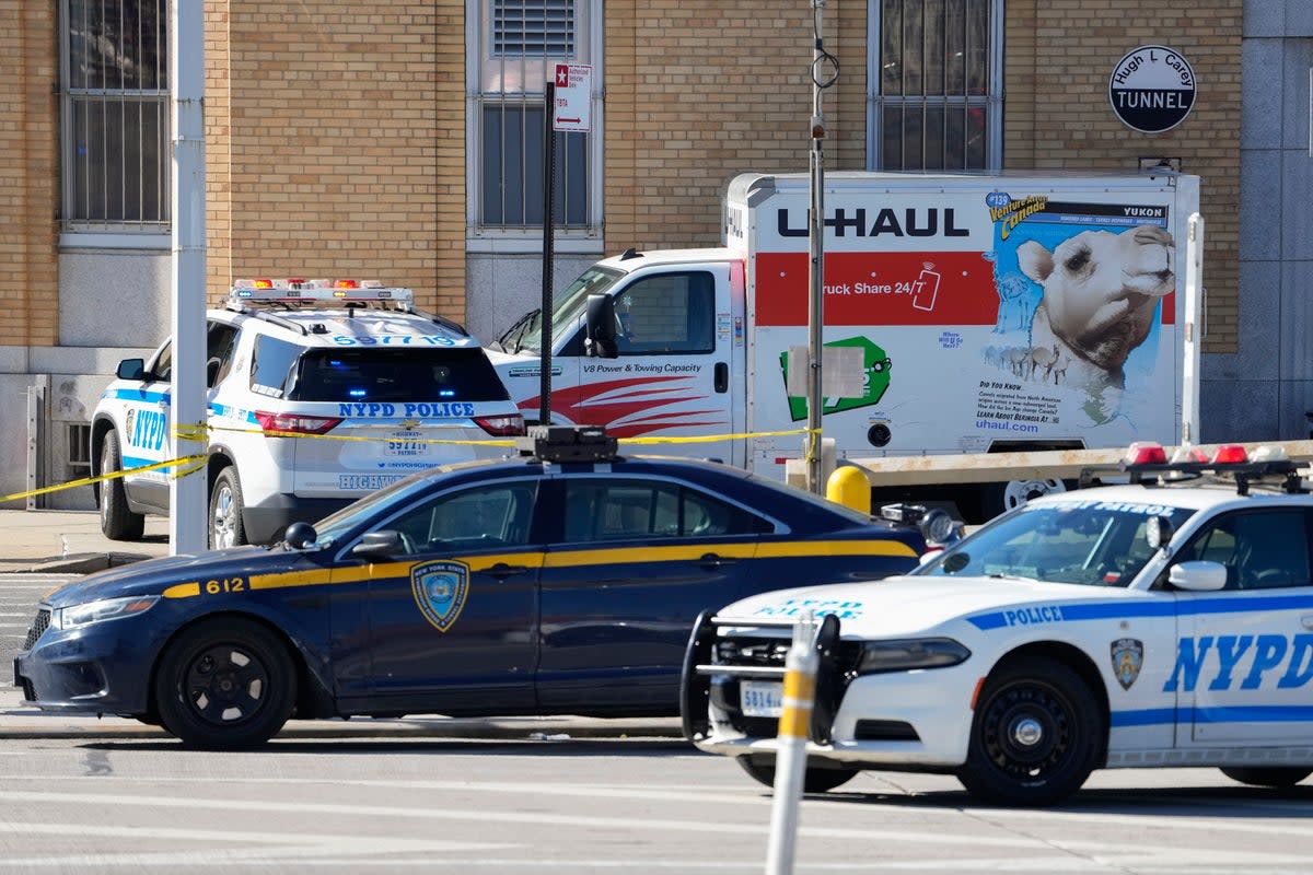 Police vehicles surround a truck that was stopped after its driver rammed into pedestrians (Associated Press)