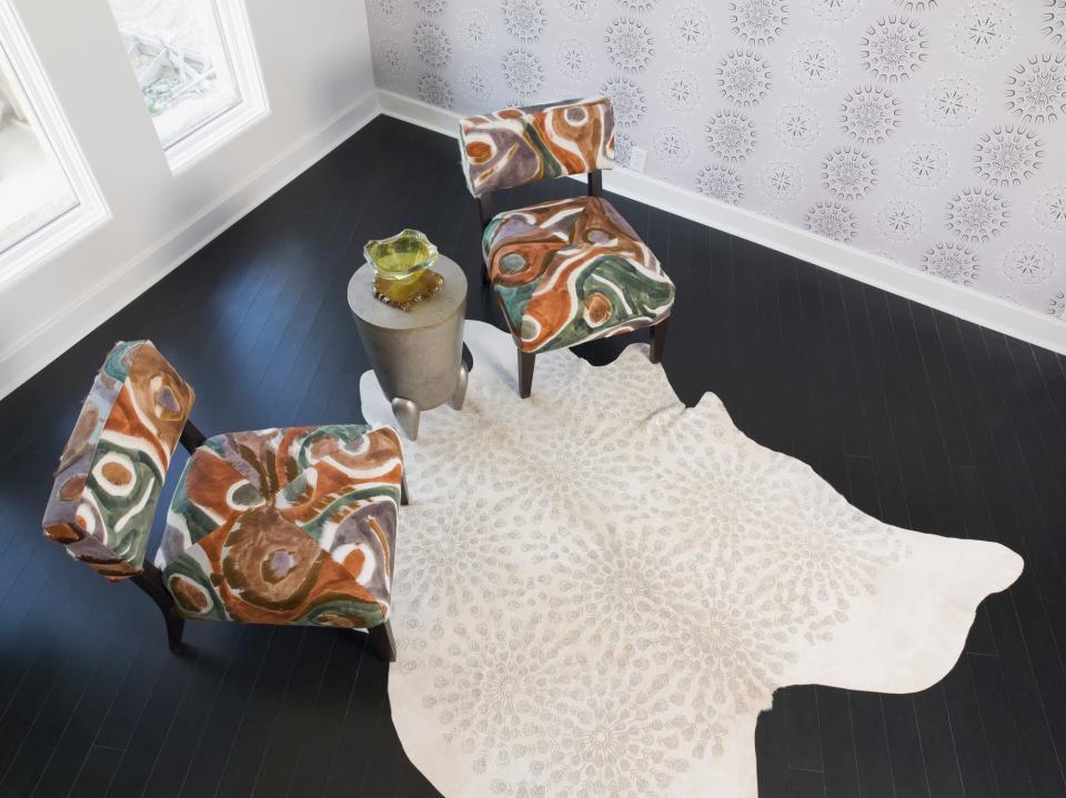 Hide rug under patterned chairs