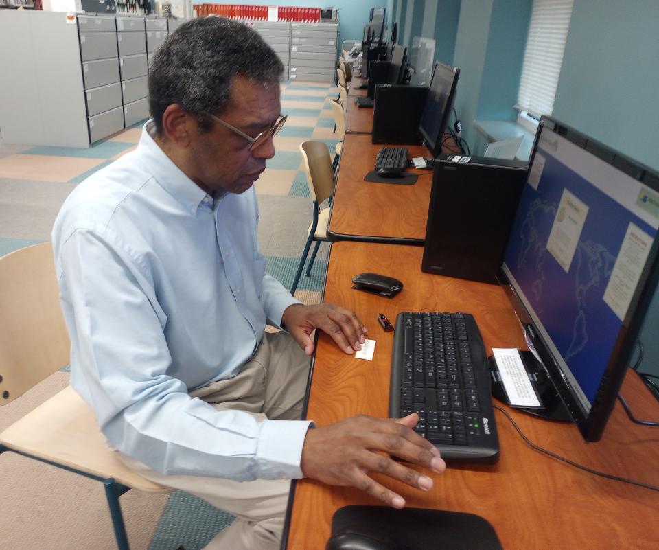 Kevin Johnson loads research on what's thought to be Erie's earliest Underground Railroad station on a computer in the Heritage Room of Blasco Library on Jan. 19.