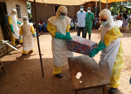 FILE PHOTO: Healthcare worker carry a coffin with a baby suspected of dying of Ebola during the funeral in Beni, North Kivu Province of Democratic Republic of Congo, December 18, 2018. REUTERS/Goran Tomasevic/File Photo