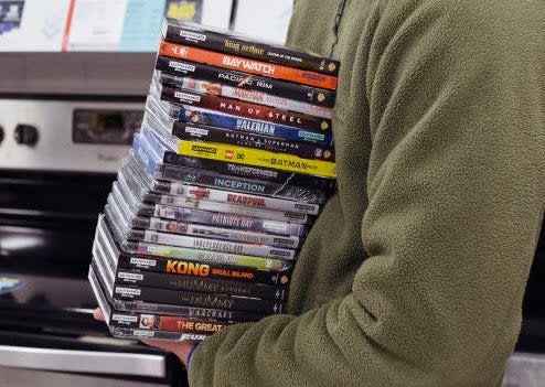 Someone holding a stack of DVDs