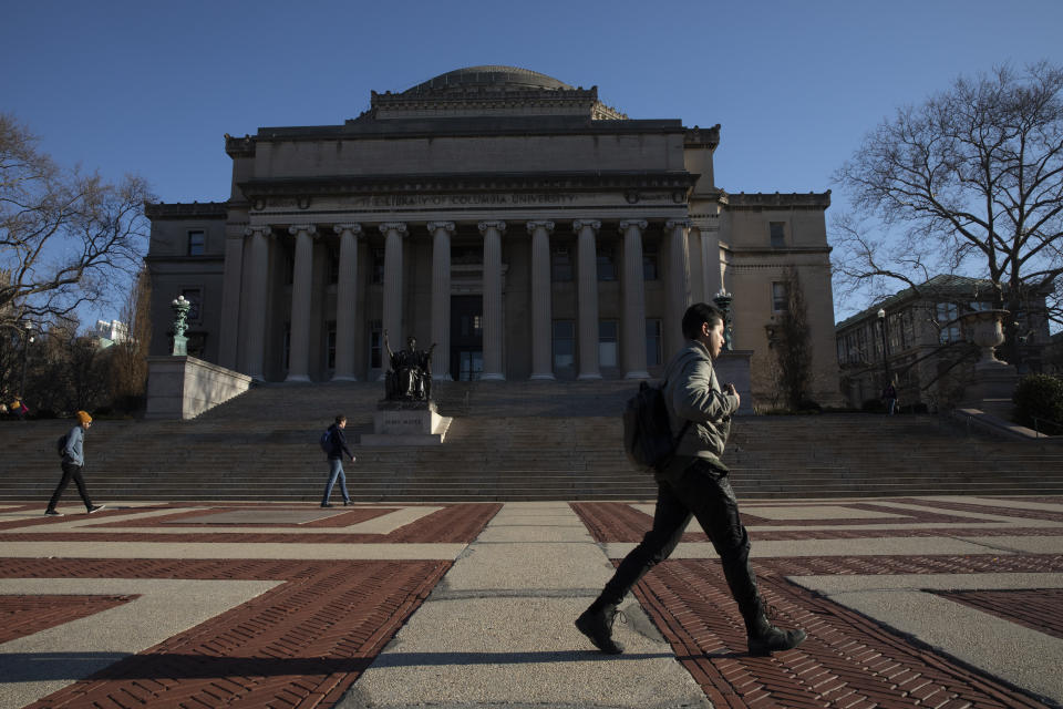 A man walks past Low Library on the Columbia University campus, Monday, March 9, 2020, in New York. The Ivy League school is canceling two days of classes this week because a person at the New York school is under quarantine from the rapidly spreading coronavirus, according to university president Lee Bollinger. (AP Photo/Mark Lennihan)
