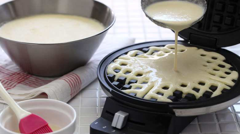 pouring waffle batter in waffle maker