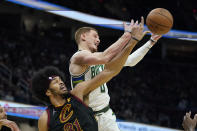 Cleveland Cavaliers' Jarrett Allen (31) and Milwaukee Bucks' Donte DiVincenzo (0) battle for a the ball in the second half of an NBA basketball game, Wednesday, Jan. 26, 2022, in Cleveland. The Cavaliers won 115-99. Jarrett Allen(AP Photo/Tony Dejak)