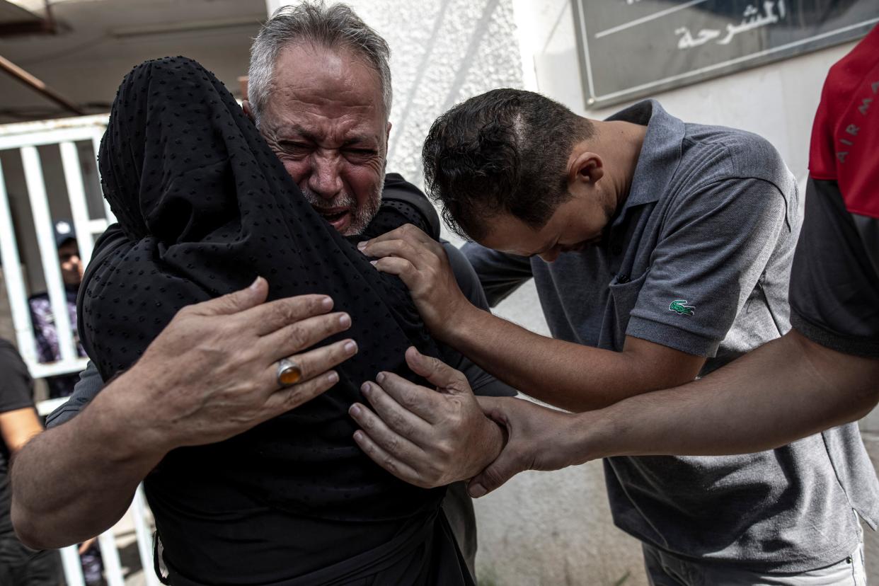 Relatives of Muhammad Hassouna, who was killed in an Israeli airstrike mourn before his funeral outside a hospital in Rafah, in the southern Gaza Strip, Sunday, Aug. 7, 2022. An Israeli airstrike in Rafah killed a senior commander in the Palestinian militant group Islamic Jihad, authorities said Sunday, its second leader to be slain amid an escalating cross-border conflict. (AP Photo/Fatima Shbair)