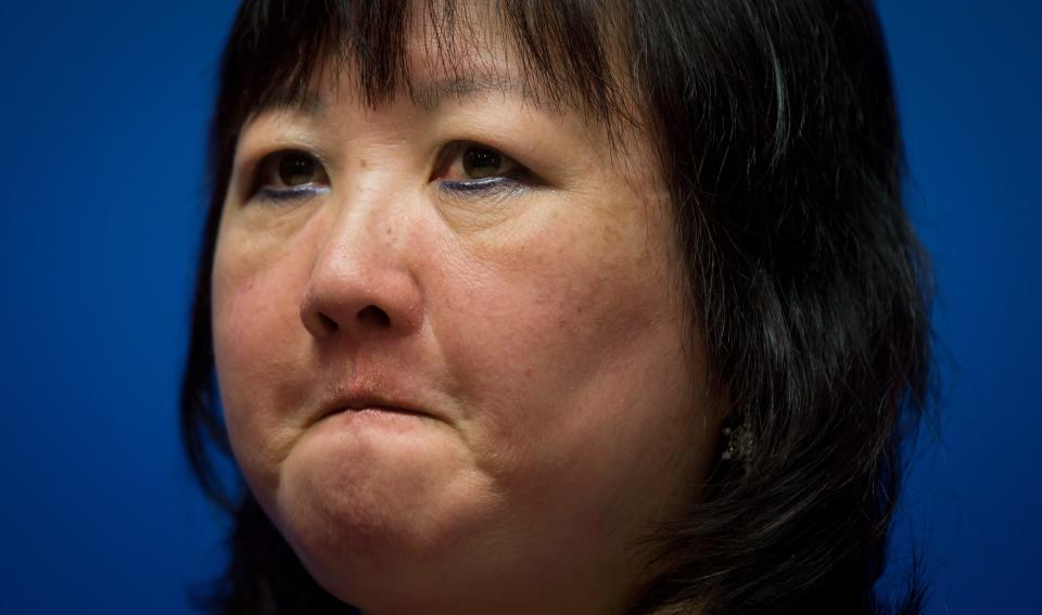 Carol Todd fights back tears as she listens during a Royal Canadian Mounted Police news conference in Surrey, British Columbia, on Thursday, April 17, 2014. A 35-year-old man alleged to be involved with the online extortion of Todd's 15-year-old daughter, who committed suicide in 2012, has been arrested in the Netherlands. (AP Photo/The Canadian Press, Darryl Dyck)