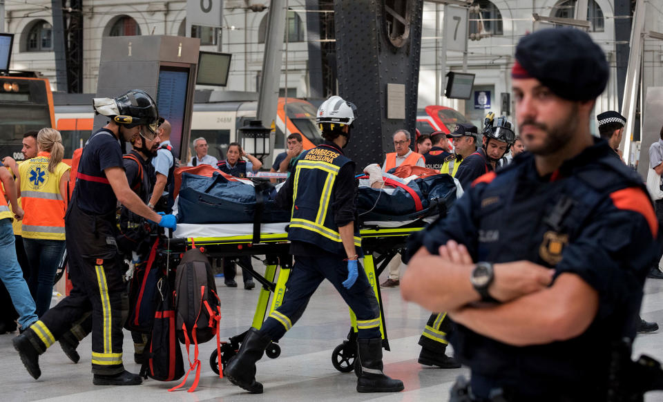 <p>An injured passenger is taken away on a stretcher from a train station in Barcelona, Spain, Friday July 28, 2017. (Photo: Adrian Quiroga/AP) </p>