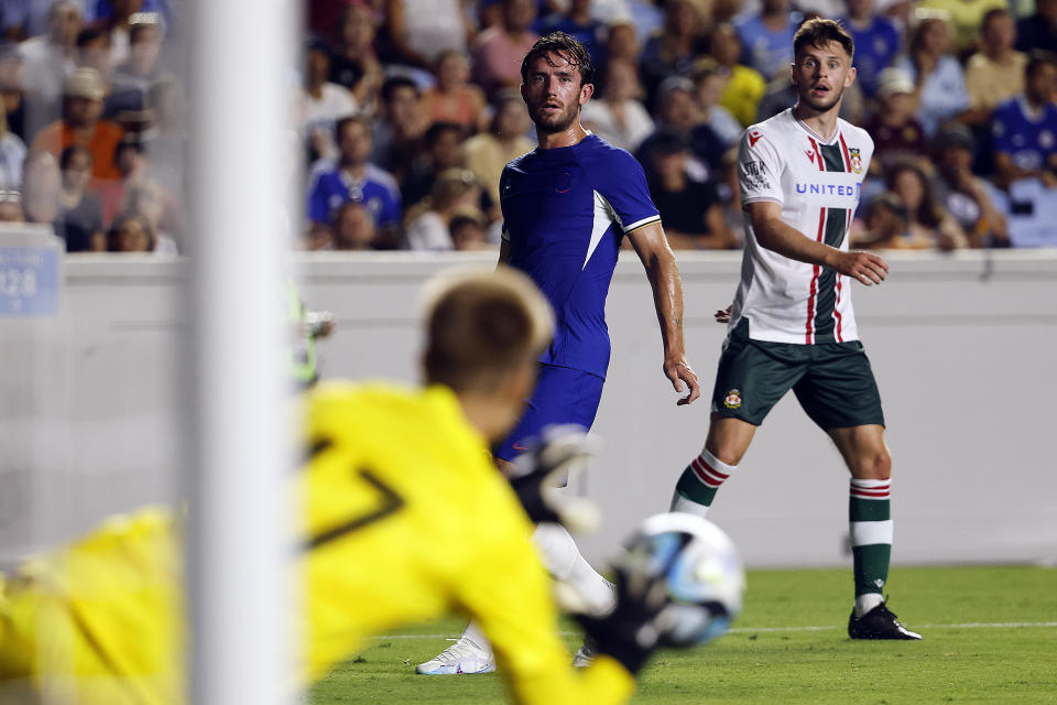 Wrexham's Liam McAlinden, right, wins a battle with Chelsea's Ben Chilwell, center, to shoot the ball at goalie Lucas Bergstrom (47) during the second half of a club friendly soccer match Wednesday, July 19, 2023, in Chapel Hill, N.C. (AP Photo/Karl B DeBlaker)