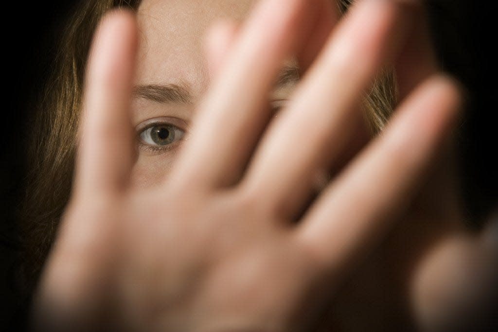 A woman holds up her hands in self-defense. Domestic violence advocates are urging Oklahoma lawmakers to increase funding for shelters.